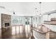 Open-concept kitchen and living room with a stone fireplace, hardwood floors, and modern appliances at 867 Pecan Tree Ln, Fort Mill, SC 29715