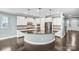 Modern kitchen with white cabinets, stainless steel appliances, a large island, and granite countertops at 867 Pecan Tree Ln, Fort Mill, SC 29715
