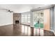 Living room features hardwood floors, stone fireplace, shiplap accent walls, and sliding doors to sunroom at 867 Pecan Tree Ln, Fort Mill, SC 29715