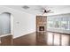 Bright living room features a stone fireplace, hardwood flooring, and large windows at 867 Pecan Tree Ln, Fort Mill, SC 29715