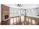 Spacious living room featuring a stone fireplace, hardwood floors, and access to the kitchen at 867 Pecan Tree Ln, Fort Mill, SC 29715