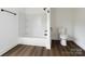 Clean bathroom featuring a white subway tiled shower/tub and a modern toilet on dark wood-look floors at 905 Gantt St, Kings Mountain, NC 28086