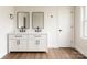 Bright bathroom features a double sink vanity, framed mirrors, black hardware and modern finishes at 905 Gantt St, Kings Mountain, NC 28086