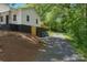 Exterior side view of home on an inclining lot showing the long gravel driveway at 905 Gantt St, Kings Mountain, NC 28086