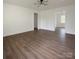 Bright, empty living room featuring modern light fixture and beautiful wood-look floors at 905 Gantt St, Kings Mountain, NC 28086