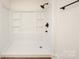 New shower with sleek fixtures, a built-in seat, and shelving at 905 Gantt St, Kings Mountain, NC 28086