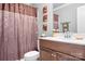Bathroom featuring a modern vanity with a dark wood finish, updated fixtures, and a shower with decorative curtains at 9112 Butterfly Ct, Gastonia, NC 28056