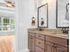 Bathroom featuring double vanity with granite countertop and dark wood cabinets at 9112 Butterfly Ct, Gastonia, NC 28056