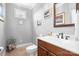 Cozy bathroom featuring wood cabinets, a white countertop, a decorative mirror, and wall decor at 9112 Butterfly Ct, Gastonia, NC 28056