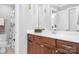 Well-lit bathroom featuring dark wood cabinets, white countertops, and elegant fixtures at 9112 Butterfly Ct, Gastonia, NC 28056