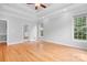 Unfurnished bedroom featuring hardwood floors, trey ceiling, and multiple windows at 9112 Butterfly Ct, Gastonia, NC 28056