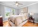 Comfortable bedroom with a large window, neutral-toned walls, hardwood floors, and a ceiling fan at 9112 Butterfly Ct, Gastonia, NC 28056
