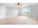 Neutral bedroom featuring carpet, a ceiling fan, a window with blinds, and a walk-in closet at 9112 Butterfly Ct, Gastonia, NC 28056