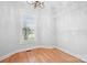 Bright closet featuring hardwood floors, shelving units, a window, and overhead lighting at 9112 Butterfly Ct, Gastonia, NC 28056