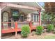 Inviting covered deck featuring brick accents, a TV, and a cozy seating area for relaxing and entertaining outdoors at 9112 Butterfly Ct, Gastonia, NC 28056