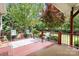 Outdoor deck area with chairs and lush greenery in the background, great for relaxation at 9112 Butterfly Ct, Gastonia, NC 28056