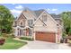 Beautiful two-story brick home with a well-manicured lawn, large two-car garage, and charming front porch at 9112 Butterfly Ct, Gastonia, NC 28056