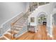 Elegant foyer with hardwood floors, staircase with wrought iron spindles, and decorative wall paneling at 9112 Butterfly Ct, Gastonia, NC 28056