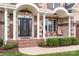 Charming front porch with brick steps, white columns, and seating area, adding to the home's curb appeal at 9112 Butterfly Ct, Gastonia, NC 28056