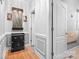 Hallway with hardwood floors, wainscoting, modern sconces, and access to multiple rooms at 9112 Butterfly Ct, Gastonia, NC 28056
