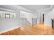 Hallway with wood floors, wood and iron railings, modern lighting, crown molding, and access to rooms at 9112 Butterfly Ct, Gastonia, NC 28056