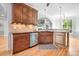 Well-equipped kitchen featuring wood cabinetry, tile backsplash, and breakfast bar area at 9112 Butterfly Ct, Gastonia, NC 28056