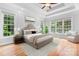 Staged primary bedroom with large windows and plenty of natural light at 9112 Butterfly Ct, Gastonia, NC 28056
