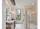 Modern bathroom featuring double sinks, granite countertops, and a glass-enclosed shower at 956 Warren Burgess Ln, Charlotte, NC 28205