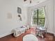 Bright bedroom with hardwood floors, a comfy bed, and a sunny window at 956 Warren Burgess Ln, Charlotte, NC 28205