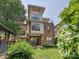 Three story townhome with manicured lawn and covered entry porch at 956 Warren Burgess Ln, Charlotte, NC 28205