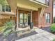 Charming brick home with a covered front porch and landscaped garden at 956 Warren Burgess Ln, Charlotte, NC 28205