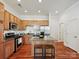 Modern kitchen boasts stainless appliances, granite counters, and hardwood floors at 956 Warren Burgess Ln, Charlotte, NC 28205