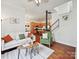 Bright living room overlooking modern kitchen and staircase features hardwood floors at 956 Warren Burgess Ln, Charlotte, NC 28205