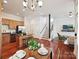 Open-concept living space with kitchen, dining, and living room featuring hardwood floors at 956 Warren Burgess Ln, Charlotte, NC 28205