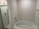 Bathroom showcasing a shower and soaking tub at 9730 Tea Garden Dr, Gastonia, NC 28056