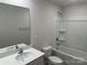 Bright bathroom has a tub-shower combo and modern sink at 9730 Tea Garden Dr, Gastonia, NC 28056