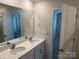 A bathroom with double sinks and large mirror at 9730 Tea Garden Dr, Gastonia, NC 28056