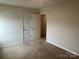 Neutral bedroom features an open closet and ensuite bathroom at 9730 Tea Garden Dr, Gastonia, NC 28056