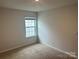 Bright bedroom with neutral carpeting and window at 9730 Tea Garden Dr, Gastonia, NC 28056