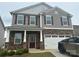 Charming two-story home featuring stone accents, a two-car garage, and a welcoming front porch at 9730 Tea Garden Dr, Gastonia, NC 28056