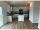 Modern kitchen with white cabinets, stainless steel appliances, dark countertops, and a center island at 9730 Tea Garden Dr, Gastonia, NC 28056