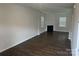 Spacious living room features dark wood flooring, a cozy fireplace, and ample natural light at 9730 Tea Garden Dr, Gastonia, NC 28056