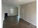 Spacious living room featuring dark wood flooring, a cozy fireplace, and an open layout at 9730 Tea Garden Dr, Gastonia, NC 28056