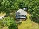 Aerial view of a charming home surrounded by lush greenery and a large backyard at 9929 Kerns Rd, Huntersville, NC 28078