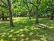 Green backyard featuring picnic table, mature trees, and ample space for outdoor activities at 9929 Kerns Rd, Huntersville, NC 28078