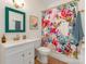 Bright bathroom featuring a colorful floral shower curtain and modern fixtures at 9929 Kerns Rd, Huntersville, NC 28078