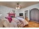 Cozy bedroom with a floral bedspread, wood floors, and a decorative fireplace at 9929 Kerns Rd, Huntersville, NC 28078