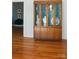 Dining room featuring hardwood floors and a glass-doored china cabinet with decorative pottery at 9929 Kerns Rd, Huntersville, NC 28078