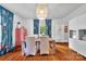Bright dining room with a wooden table, ornate fireplace and colorful curtains at 9929 Kerns Rd, Huntersville, NC 28078