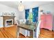 Bright dining room with a wooden table, ornate fireplace and colorful curtains at 9929 Kerns Rd, Huntersville, NC 28078